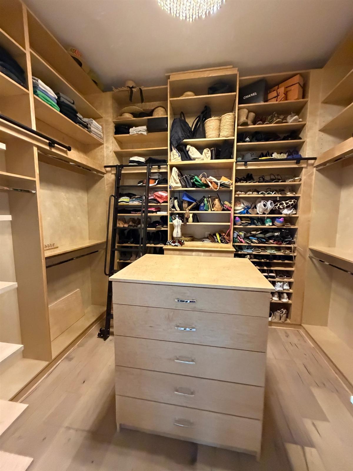 Birch walk-in closet with center island and shoe wall