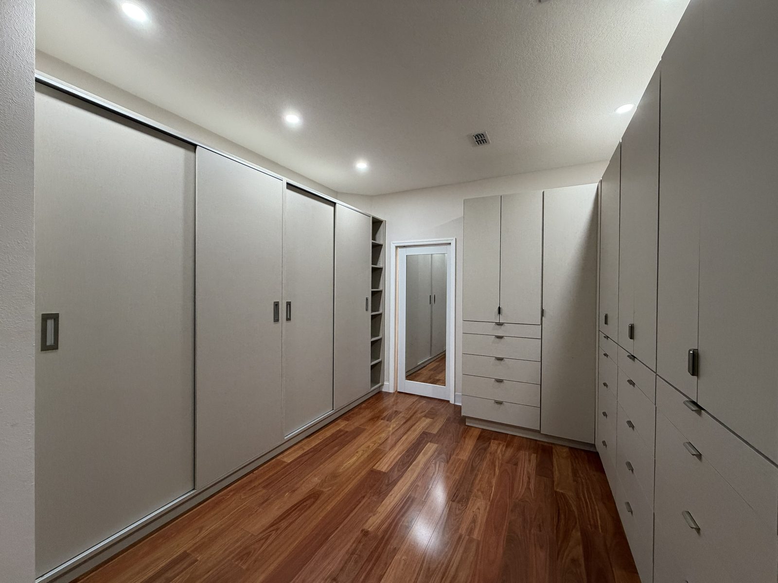 Tall white pantry with wire baskets